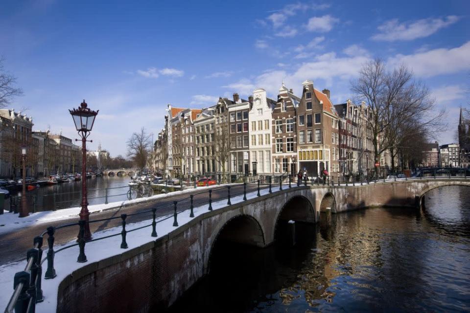 General view of the canals in Amsterdam, Netherlands. Amsterdam with its many canals and bridges, often referred to as the Venice of the North, is the country's tourist and financial capital.