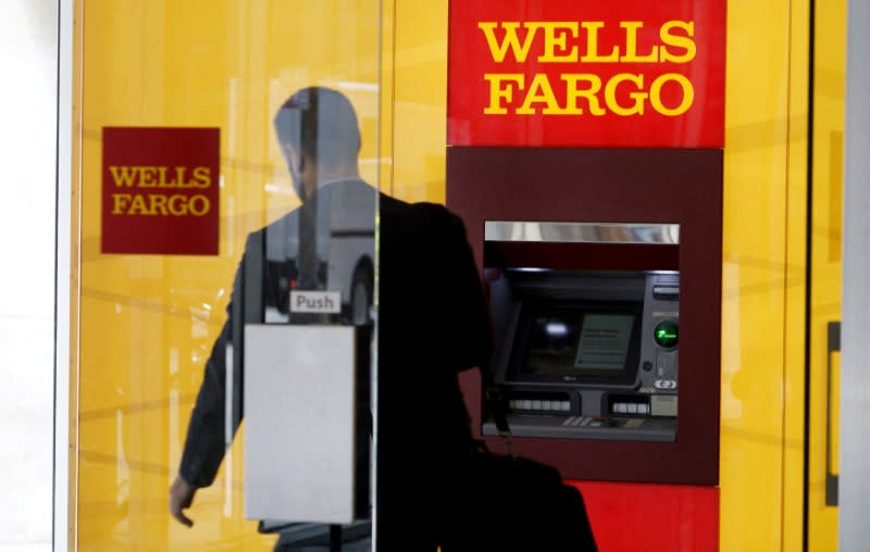 FILE PHOTO: A man walks by an ATM at the Wells Fargo & Co. bank in downtown Denver April 13, 2016.  REUTERS/Rick Wilking/File Photo