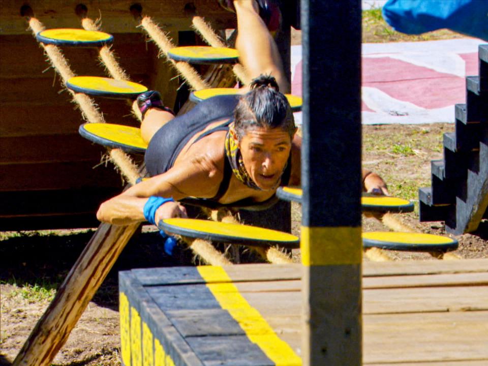 Denise Stapley crawling across a yellow bridge during challenge on "Survivor: Winners at War"