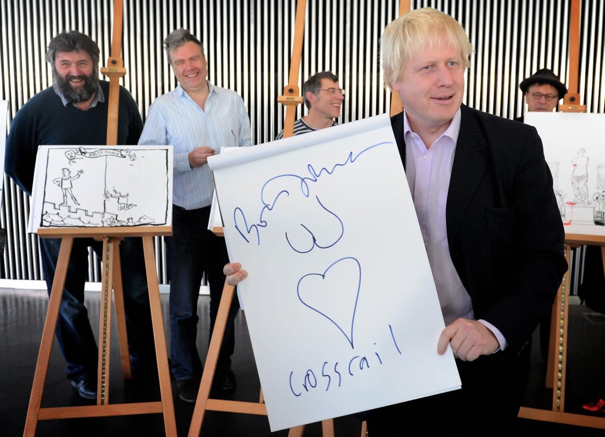 Steve Bell of The Guardian (left) with London Mayor Boris Johnson as he shows off a drawing he made at City Hall after taking lessons from Britain’s top cartoonists (PA)