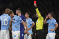 Referee Orel Grinfeld of Israel shows a red card to Malmo's Rasmus Bengtsson, second left, during the round of 32, second leg, Europa League soccer match between Chelsea and Malmo FF at Stamford Bridge stadium in London, Thursday Feb. 21, 2019. (AP Photo/Frank Augstein)