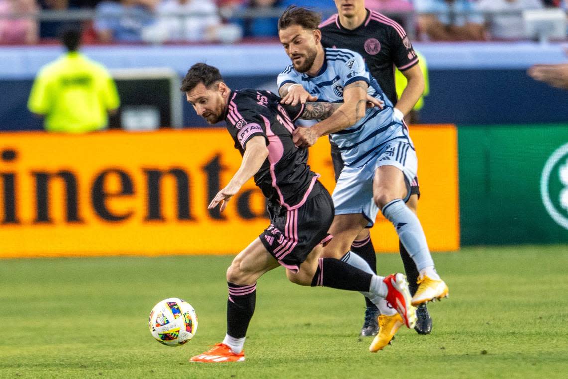 Inter Miami forward Lionel Messi (10) shields the ball from Sporting Kansas City defender Robert Voloder (4) in the first half of an MLS game against Sporting Kansas City at GEHA Field at Arrowhead Stadium on Saturday, April 13, 2024, in Kansas City.