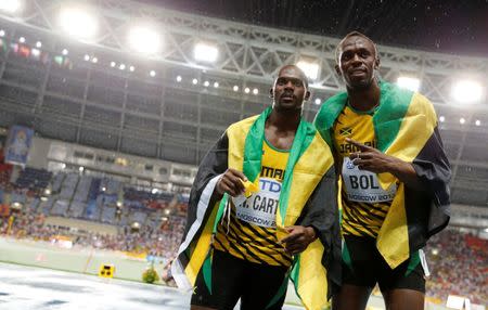 FILE PHOTO: First placed Usain Bolt (R) of Jamaica poses with his compatriot third placed Nesta Carter after competing in the men's 100 metres final during the IAAF World Athletics Championships at the Luzhniki stadium in Moscow August 11, 2013. REUTERS/Dominic Ebenbichler/File photo Picture Supplied by Action Images