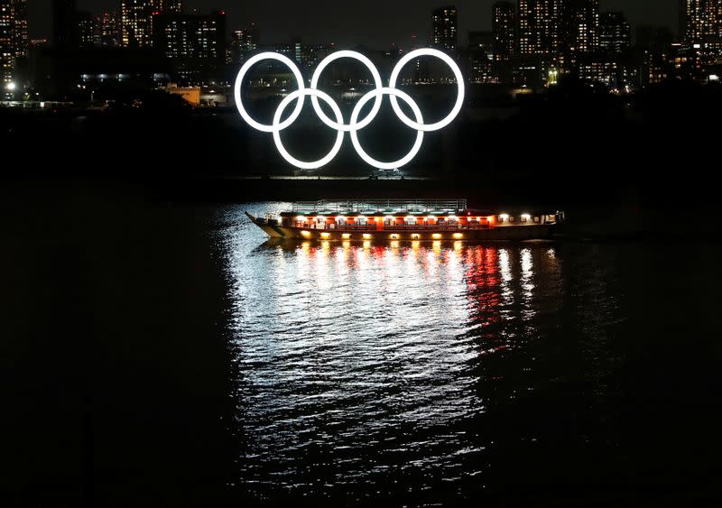 FILE PHOTO: A Japanese-style tour boat sails in front of giant Olympic rings at the waterfront area during the spread of the coronavirus disease (COVID-19) in Tokyo