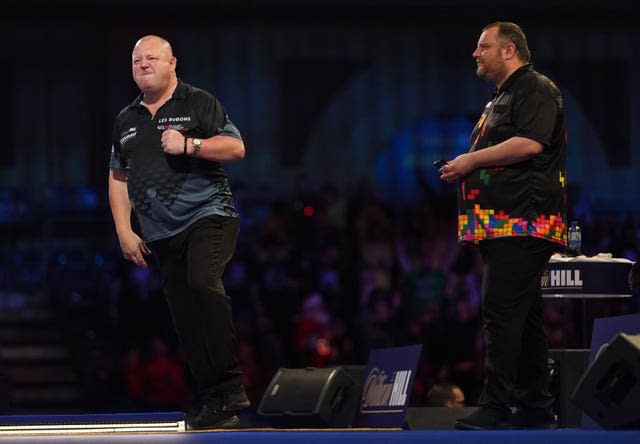Mervyn King (left) in action against Ryan Joyce (right) at the PDC World Darts Championship