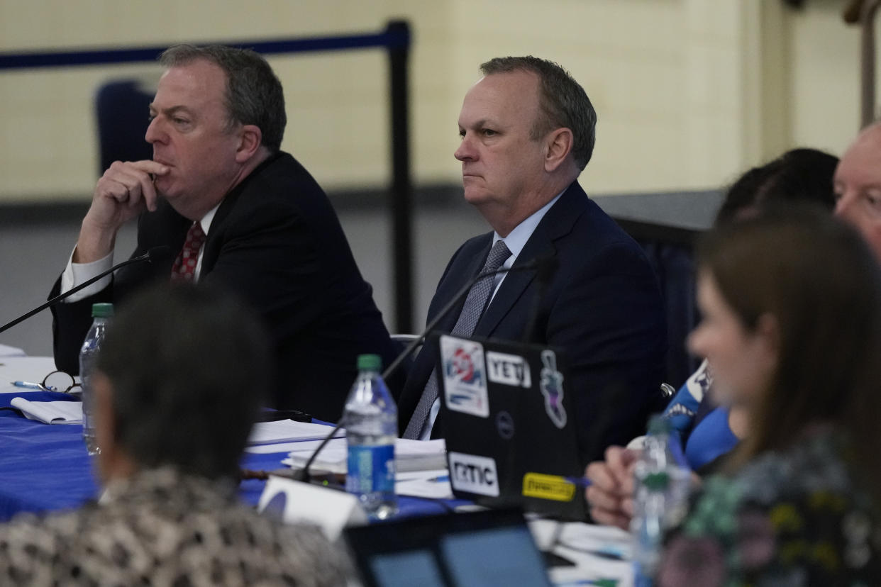 FILE -New College of Florida's interim President Richard Corcoran, center, listens during a meeting of the college's board of trustees, alongside trustee Matthew Spalding, left, Tuesday, Feb. 28, 2023, in Sarasota, Fla. In January, Gov. Ron DeSantis and his allies overhauled the school's 13-member board and installed a majority of conservative figures. The new trustees promptly fired the college president and replaced her with a Republican politician, the first of several administrators to lose their jobs. (AP Photo/Rebecca Blackwell, File)