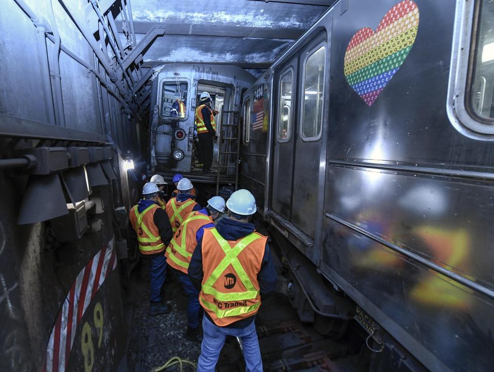 This photo provided by The Metropolitan Transportation Authority (MTA) shows emergency personnel at the scene of a train derailment of a New York City subway car, Thursday, Jan. 4, 2024. A New York City subway train derailed Thursday after colliding with another train, leaving more than 20 people with minor injuries including some who were brought to hospitals, the New York City Police Department said. (Metropolitan Transportation Authority via AP)