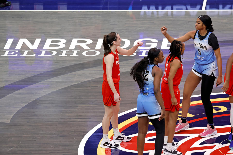 INDIANAPOLIS, IN - JUNE 01: Chicago Sky forward Angel Reese (5) and Indiana Fever guard Caitlin Clark (22) fist bump before the opening jump ball on June 1, 2024, at Gainbridge Fieldhouse in Indianapolis, Indiana. (Photo by Brian Spurlock/Icon Sportswire via Getty Images)