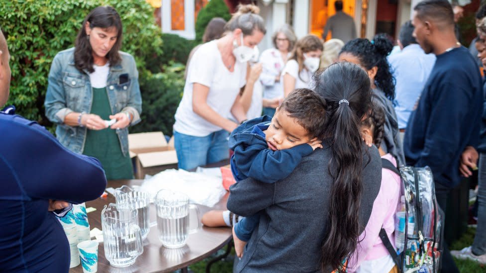 Una mujer con un niño en sus brazos, parte de los migrantes enviados a Martha's Vineyard.