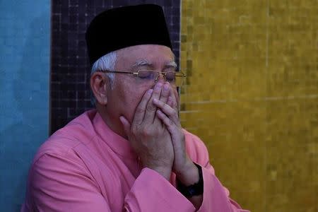 Malaysia’s former Prime Minister Najib Razak prays before he attends the United Malays National Organisation (UMNO) 72th anniversary celebrations in Kuala Lumpur, Malaysia May 11, 2018. REUTERS/Stringer