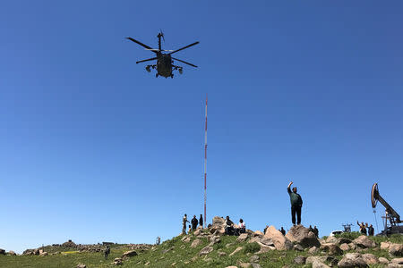 A helicopter carrying U.S. military officials arrive at the headquarters of the Kurdish fighters from the People's Protection Units (YPG) that was hit by Turkish airstrikes in Mount Karachok near Malikiya, Syria. REUTERS/Rodi Said