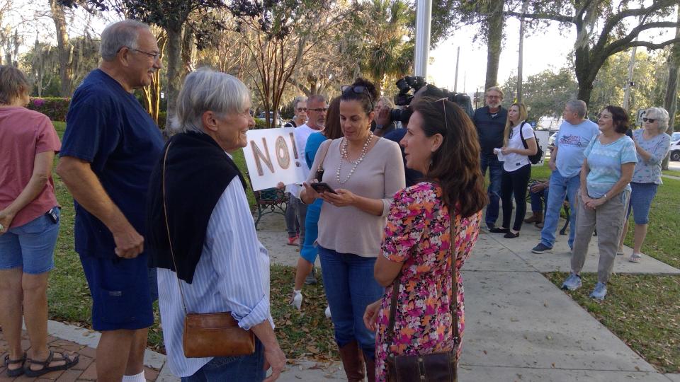 People mill outside Mount Dora City Hall prior to the Feb. 21 meeting to determine the fate of the proposed multi-
use development.
