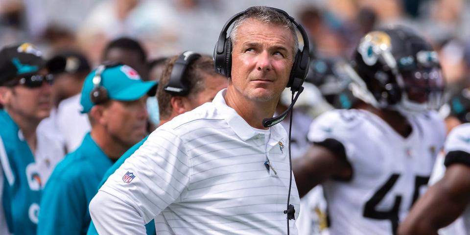 Urban Meyer looks up while standing on the sideline during a Jaguars game.