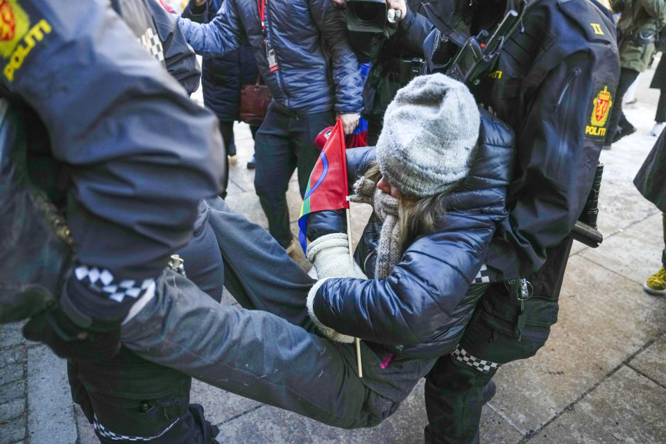 FILE - Swedish activist Greta Thunberg is carried away during a protest outside the Norwegian Ministry of Finance, in Oslo, on March 1, 2023. Norway reached Wednesday an agreement with the Sami people ending a dispute over Indigenous right that led to activists blocking several entrances to Norwegian government offices over a wind farm that they say hinders the rights of the Indigenous people to raise reindeer. At the center of the dispute are the 151 turbines of Europe’s largest onshore wind farm, which is located in central Norway’s Fosen district, about 450 kilometers (280 miles) north of the capital, Oslo. (Javad Parsa//NTB Scanpix via AP)