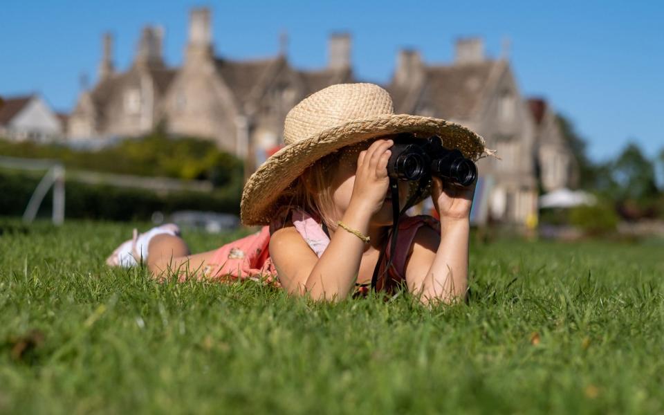 Child peering through binoculars at Woolley Grange, Bradford-on-Avon - Luxury Family Hotels