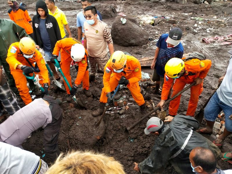 Indonesia rescue agency search for a body at an area affected by flash floods after heavy rains