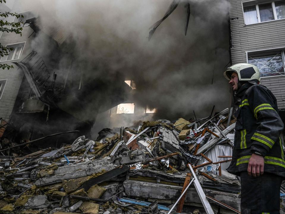 A firefighter reacts during extinguishing a fire after a flat was hit by a missile strike in Donetsk (AFP via Getty Images)