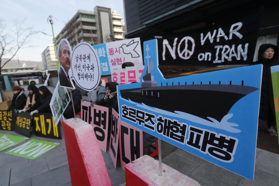 Anti-war activists stage a rally against the South Korean government's decision to send troops to Hormuz Strait, near the U.S. Embassy in Seoul, South Korea, Tuesday, Jan. 21, 2020. South Korean government on Tuesday said in a press release that the government had decided to send troops to Hormuz Strait to protect South Korean citizens and guarantee the freedom of navigation in the region. The sign reads "Dispatch of Hormuz Strait." (AP Photo/Ahn Young-joon)