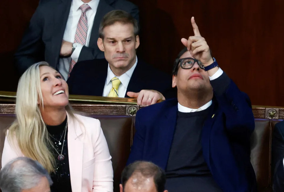 Newly elected freshman Rep. George Santos (R-NY), facing a ungraded   implicit    his resume and claims helium  made connected  the run  trail, points to the ceiling of the House Chamber arsenic  helium  talks with Rep. Jim Jordan (R-OH) and Rep. Marjorie Taylor Greene (R-GA) during a 9th circular  of votes for the caller   Speaker of the House connected  the 3rd  time  of the 118th Congress astatine  the U.S. Capitol successful  Washington, U.S., January 5, 2023. REUTERS/Evelyn Hockstein     TPX IMAGES OF THE DAY