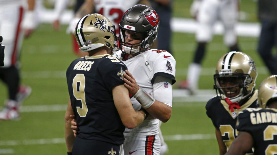 New Orleans Saints quarterback Drew Brees (9) and Tampa Bay Buccaneers quarterback Tom Brady hug after their season opening NFL football game in New Orleans, Sunday, Sept. 13, 2020. The Saints won 34-23. (AP Photo/Butch Dill)