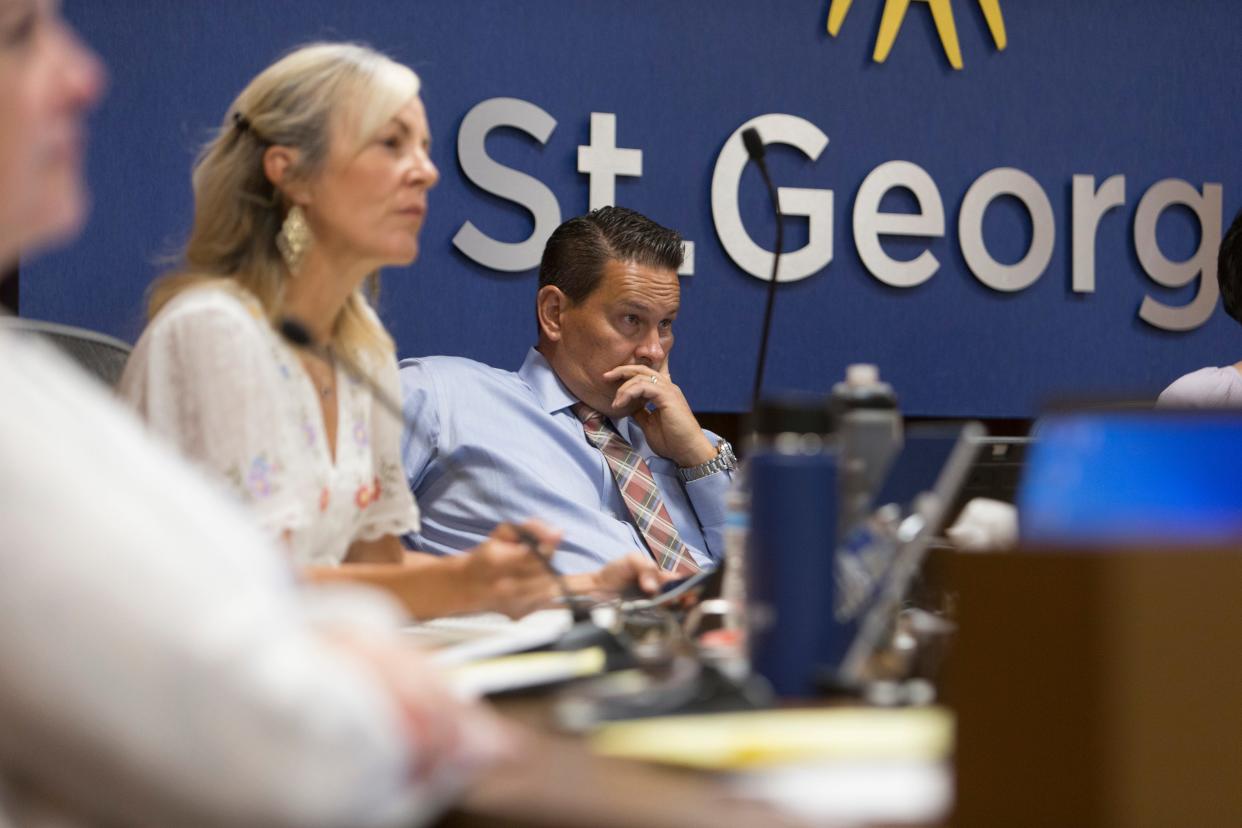 St. George City Council members Danielle Larkin and Jimmie Hughes look on as residents speak about Pride Month-related events in a 2022 meeting.