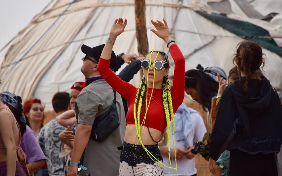 Ravers dance among the skeletons of ships at Stihia, the annual electronic music festival - Sophie Ibbotson