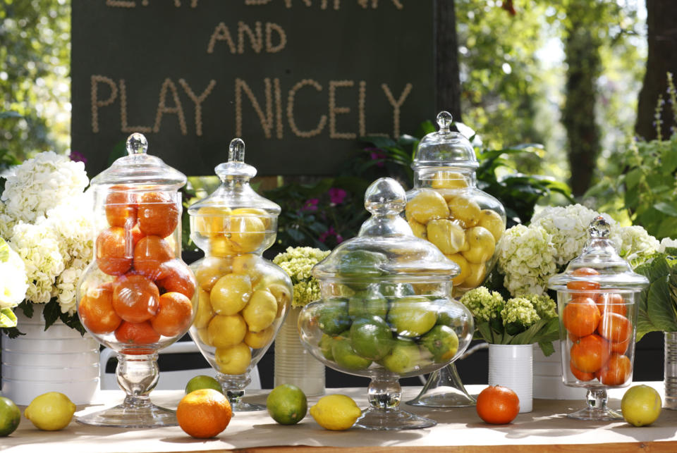 In this publicity photo provided by Brian Patrick Flynn, the Designer Brian Patrick Flynn suggests grouping fruits in clear glass vessels where he uses apothecary jars, his favorite, seen here as an alternative to greenery, when homeowners are unable to commit to proper plant care. (AP Photo/Brian Patrick Flynn/Mali Azima)