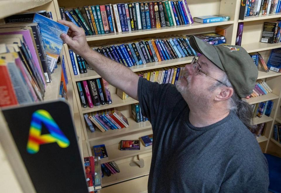 One of Bargain Books Boise’s longtime patrons, Michael Martin, browses titles among the many shelves filled with used books.