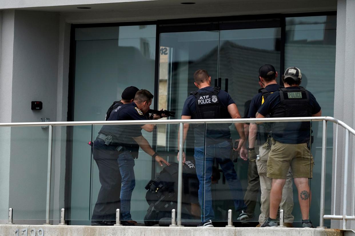 Law enforcement search in a building after a mass shooting at the Highland Park Fourth of July parade in downtown Highland Park, a Chicago suburb on Monday, July 4, 2022. 