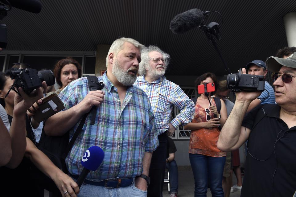 FILE - In this June 8, 2019 file photo, Co-founder and former head of Novaya Gazeta, Dmitry Muratov, foreground, and the Ekho Moskvy (Echo of Moscow) radio station's editor-in-chief, Alexei Venediktov speak to supporters of Ivan Golunov, a journalist who worked for the independent website Meduza, at a court building in Moscow, Russia. As a new Nobel Peace Prize laureate, Russian newspaper editor Dmitry Muratov has downplayed the buzz around his name. The award isn't for him, he says, but for all of the staff at Novaya Gazeta, the independent Russian newspaper noted for investigations of official corruption, human rights abuses and Kremlin criticism. (AP Photo/Dmitry Serebryakov)