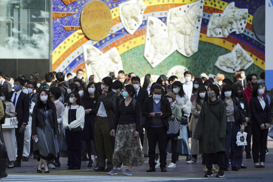 People wearing protective masks to help curb the spread of the coronavirus walk along a pedestrian crossing in Shibuya district in Tokyo on April 7, 2021. Japan is set to strengthen anti-virus measures in Tokyo on Friday, April 9, 2021 to curb the rapid spread of a more contagious coronavirus variant just three months before the Olympics begin in the capital where most people are not yet vaccinated. (AP Photo/Eugene Hoshiko)