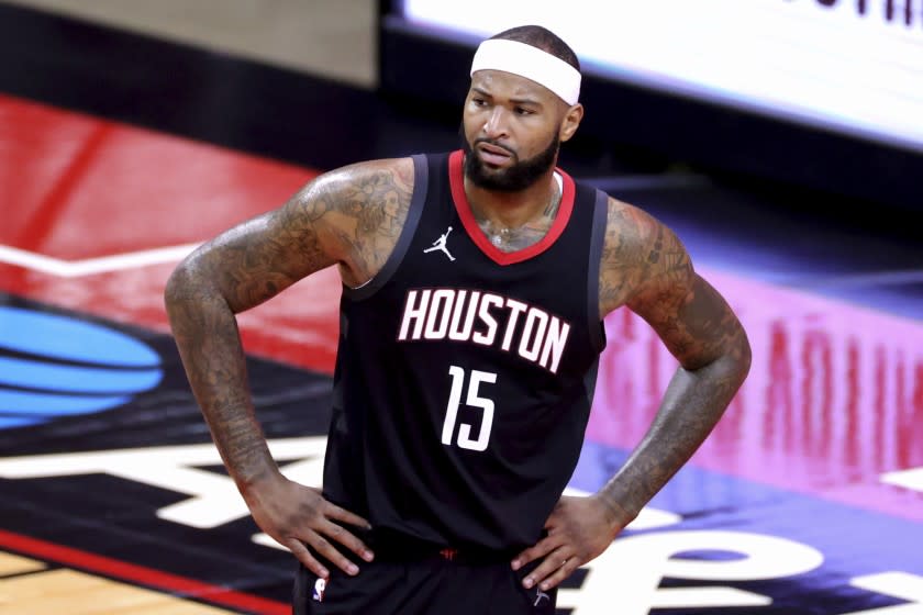 FILE - Houston Rockets' DeMarcus Cousins pauses during the fourth quarter of an NBA basketball game.