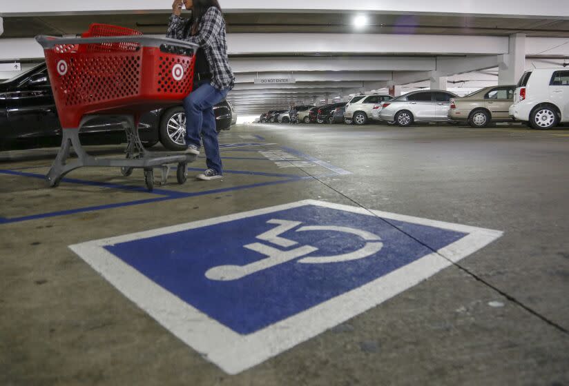 GLENDALE, CALIFORNIA, APRIL 11, 2017: An undercover officer with the Department of Motor Vehicles waits with a shopping cart next to a disabled parking spot while conducting a sweeping enforcement of fraudulent and improper use of the disabled parking placards in the Glendale Galleria April 11, 2017 (Mark Boster / Los Angeles Times ).