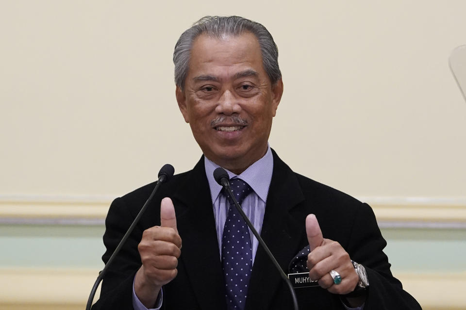 FILE - Malaysian new Prime Minister Muhyiddin Yassin thumbs up during a press conference at prime minister's office in Putrajaya, Malaysia on March 9, 2020. Muhyiddin arrived Thursday, March 9, 2023 at the anti-graft agency office for a second time in a month over alleged corruption in the award of government projects under his rule. (AP Photo/Vincent Thian, File)