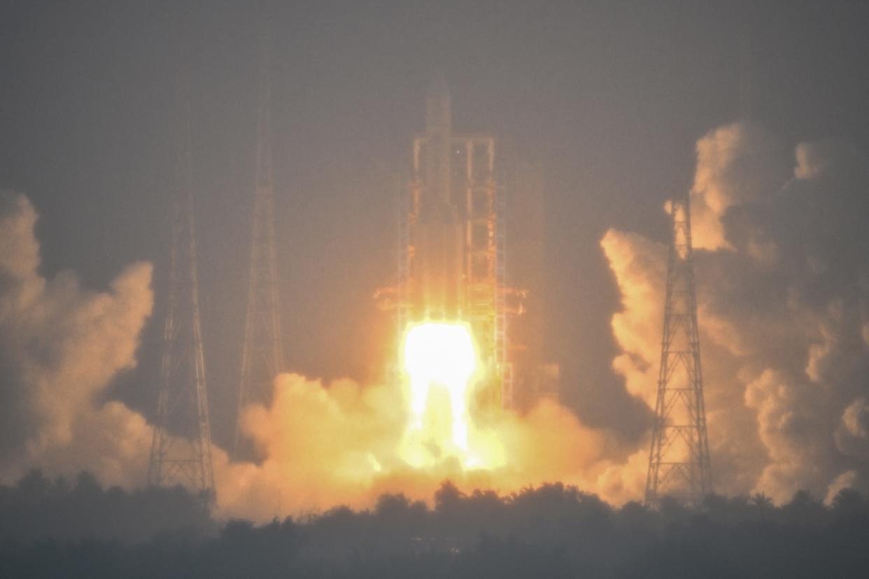 A Long March 5 rocket, carrying the Chang'e-6 mission lunar probe, lifts off Friday as it rains at the Wenchang Space Launch Centre in southern China's Hainan Province.