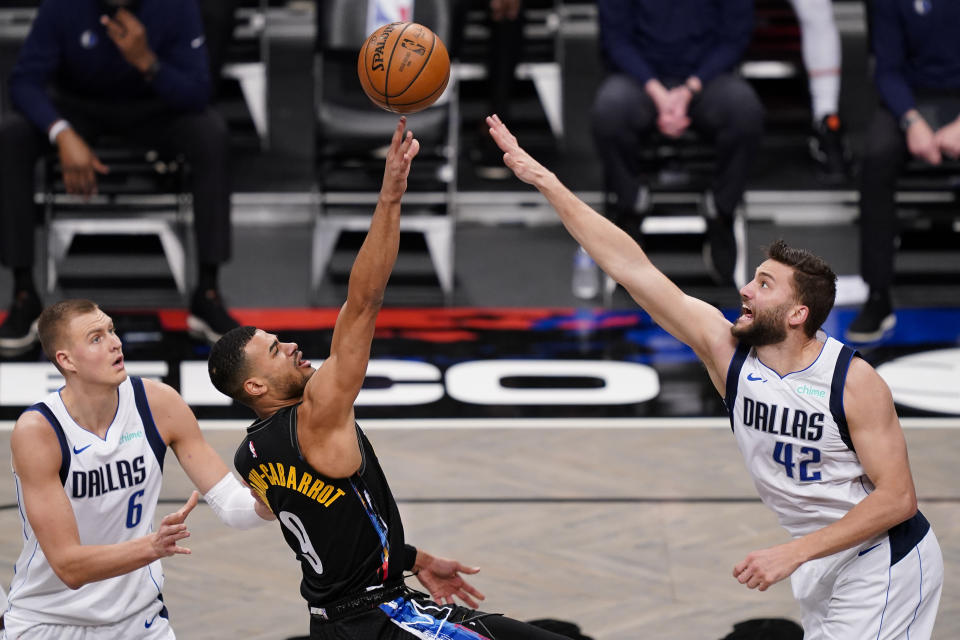 Brooklyn Nets guard Timothe Luwawu-Cabarrot (9) shoots against Dallas Mavericks forward Maxi Kleber (42) during the second half of an NBA basketball game Saturday, Feb. 27, 2021, in New York. (AP Photo/John Minchillo)