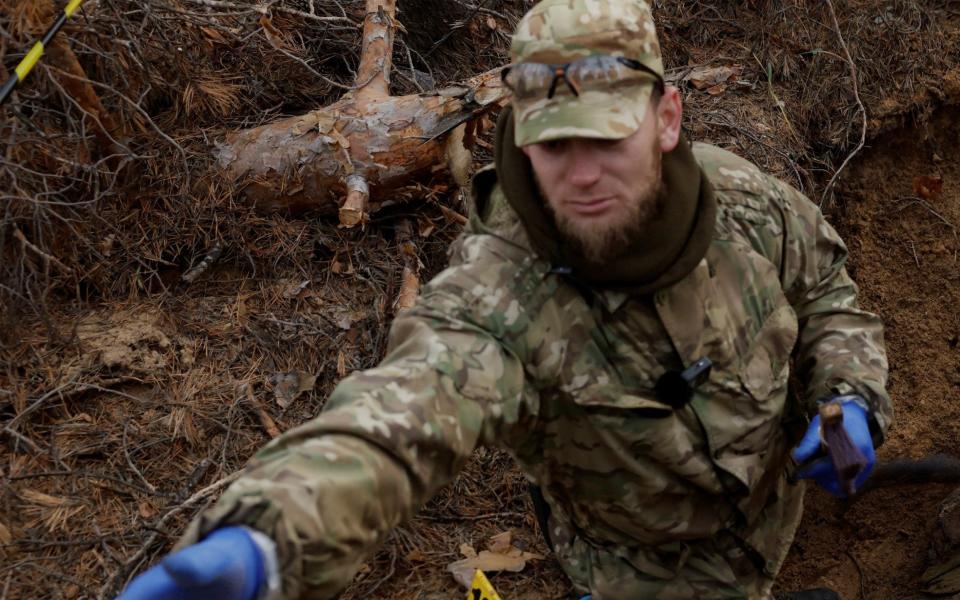 SENSITIVE MATERIAL. THIS IMAGE MAY OFFEND OR DISTURB Oleksii Lukov 37, exhumes the body of a fallen Ukrainian soldier with the humanitarian mission "Black Tulip" which searches, exhumes, and retrieves bodies of soldiers, as Russia's attack on Ukraine continues, in Yampil, Ukraine, January 2, 2023. "Black Tulip" exhumes bodies of both Ukrainian and Russian soldiers on the battlefield and trades the bodies of deceased Russian soldiers they find for the bodies of deceased Ukrainian soldiers to return to their families. REUTERS/Clodagh Kilcoyne - REUTERS/Clodagh Kilcoyne