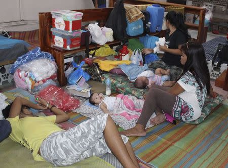 People take shelter inside a Catholic church after evacuating their homes due to super-typhoon Hagupit in Tacloban city, central Philippines December 5, 2014. REUTERS/Rowel Montes