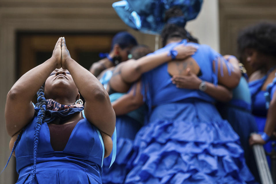 Artist Vanessa German, left, leads a ritual song during her piece, "Blue Walk," a "reckoning ritual," on May 27, 2021, outside of The Frick Art Museum in Pittsburgh. The 2.5 mile procession honored George Floyd, Breonna Taylor, Elijah McClain and other people of color whose lives have been lost to violence. A trial for two of the officers charged for Elijah McClain's death is set to begin Friday, Sept. 15, 2023 with jury selection. (Emily Matthews/Pittsburgh Post-Gazette via AP, file)