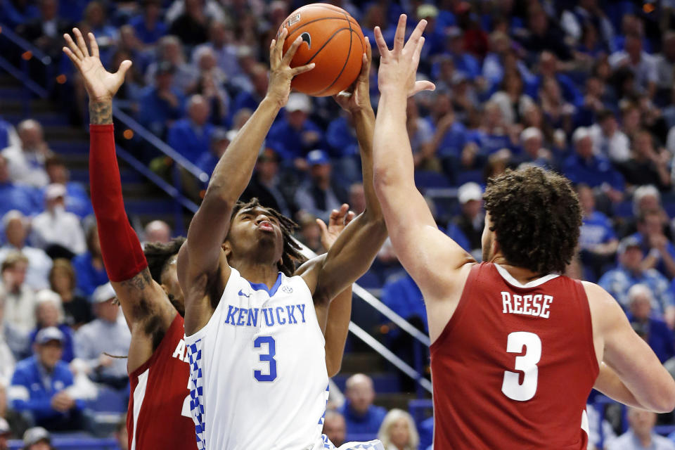 Kentucky's Tyrese Maxey (3) shoots between Alabama's John Petty Jr., left, and Alex Reese during the second half of an NCAA college basketball game in Lexington, Ky., Saturday, Jan 11, 2020. Kentucky on 76-67. (AP Photo/James Crisp)