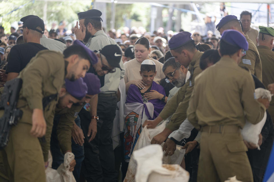 Mourners attend the funeral of Israeli soldier Sergeant Almog Shalom, who was killed in battle in the Gaza Strip, during his funeral at the Mount Herzl military cemetery in Jerusalem, Tuesday, June 11, 2024. (AP Photo/Ohad Zwigenberg)