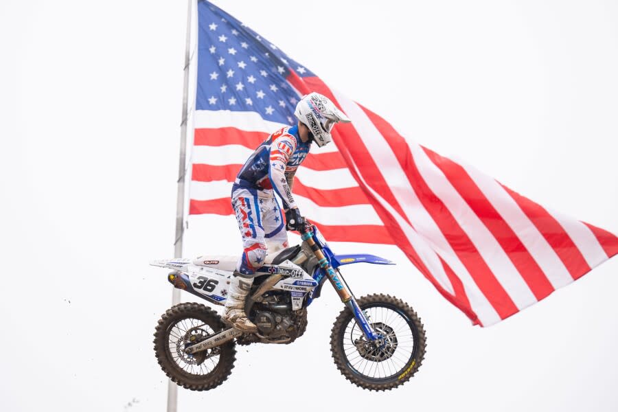 MX RedBud 2023 Garrett Marchbanks 2 jumps in front of flag.JPG