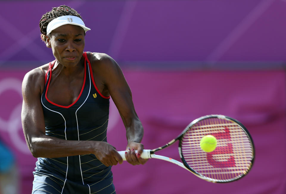 LONDON, ENGLAND - AUGUST 01: Venus Williams of the United States returns the ball to Angelique Kerber of Germany during the third round of Women's Singles Tennis on Day 5 of the London 2012 Olympic Games at Wimbledon on August 1, 2012 in London, England. (Photo by Clive Brunskill/Getty Images)