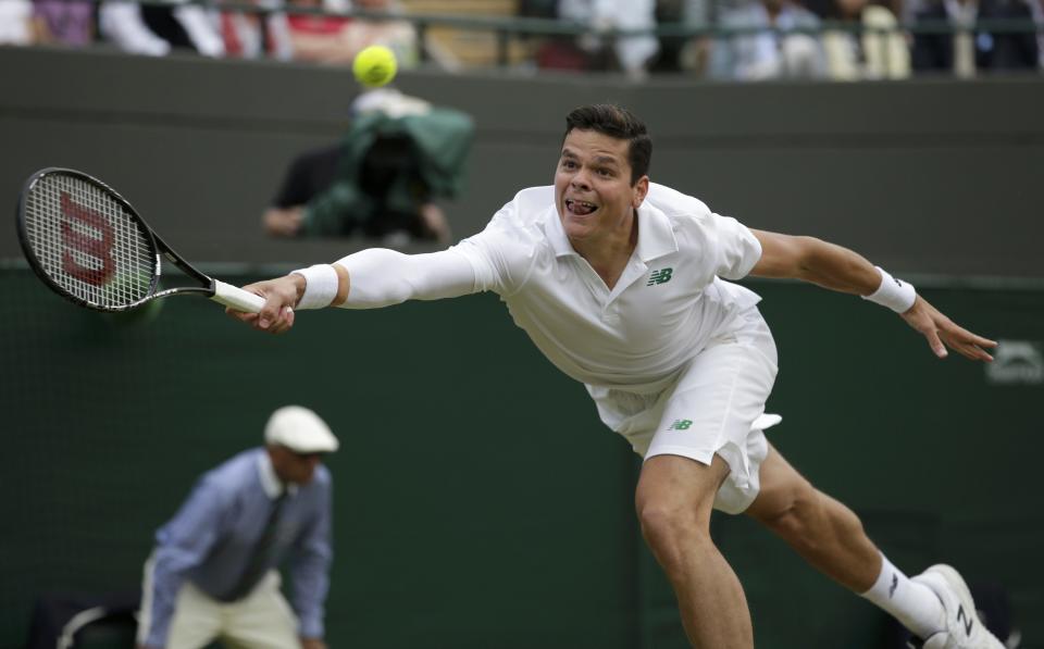 Milos Raonic of Canada hits a return during his men's singles quarter-final tennis match against Nick Kyrgios of Australia at the Wimbledon Tennis Championships, in London July 2, 2014. REUTERS/Max Rossi (BRITAIN - Tags: SPORT TENNIS TPX IMAGES OF THE DAY)