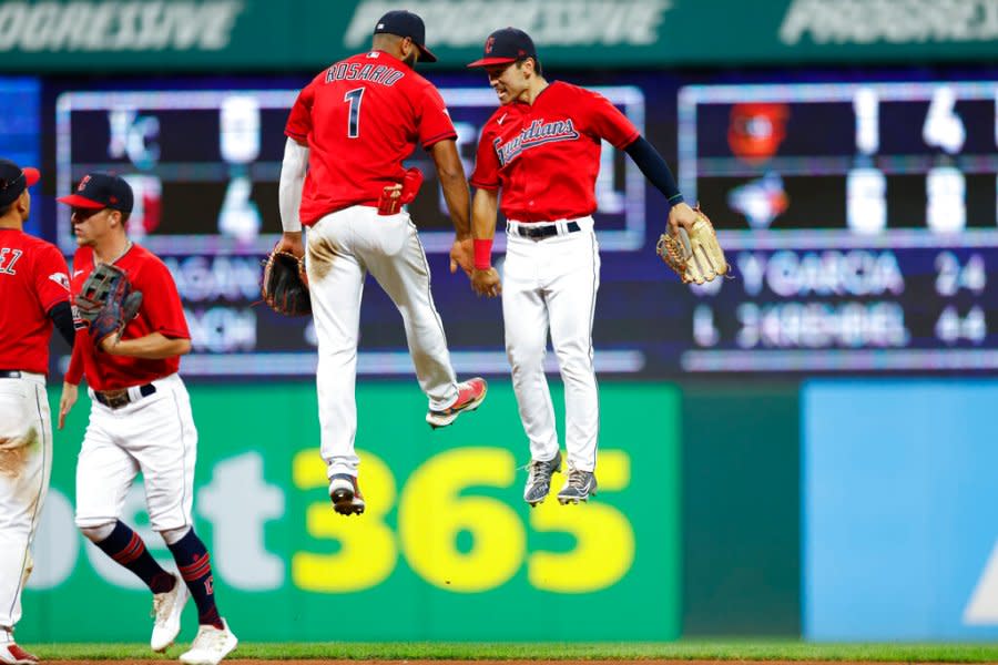 Cleveland Guardians shortstop Amed Rosario (1) and left fielder Steven Kwan celebrate an 8-4 win against the Detroit Tigers in a baseball game Wednesday, Aug. 17, 2022, in Cleveland. (AP Photo/Ron Schwane)