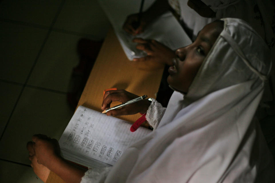 In this Friday, Oct. 11, 2013 photo, young ethnic Rohingya asylum seeker Senwara Begum from Myanmar attends an English class at her temporary shelter in Medan, North Sumatra, Indonesia. Although sympathetic to the Rohingya, Indonesia only allows the refugees to stay until they can be resettled elsewhere, which can take years. (AP Photo/Binsar Bakkara)