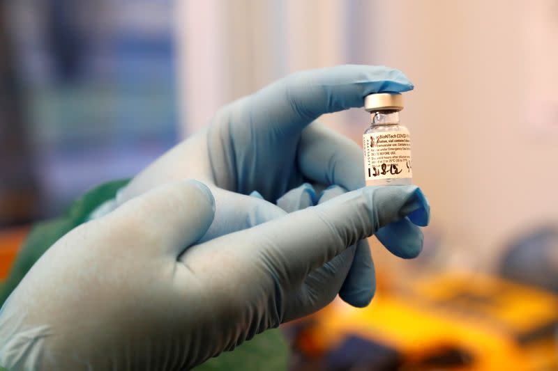 Medical worker holds Pfizer/BioNTech COVID-19 vaccine at the hospital in Ventspils