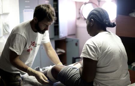 A migrant receives medicaments by a doctor on the MV Aquarius, a search and rescue ship run in partnership between SOS Mediterranee and Medecins Sans Frontieres on their way to Spain, June 15, 2018. Karpov / SOS Mediterranee/handout via REUTERS