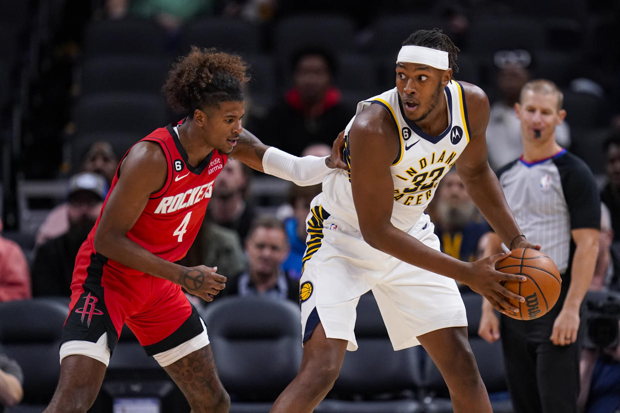 Indiana Pacers center Myles Turner (33) is defended by Houston Rockets guard Jalen Green (4) during the first half of an NBA preseason basketball game in Indianapolis, Friday, Oct. 14, 2022. (AP Photo/Michael Conroy)