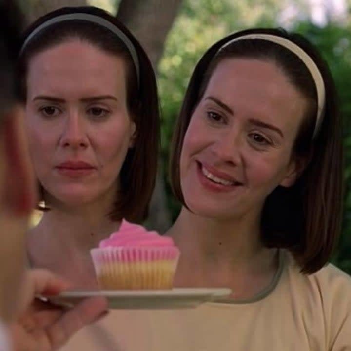 Bette and Dot being presented with a cupcake